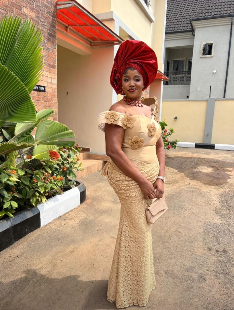 Custom gold lace dress with red gele, outdoor